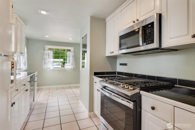 414 W Wyandotte Ave, Shelton, WA 98584 - kitchen with appliances with stainless steel finishes, white cabinetry, recessed lighting, and light tile patterned floors