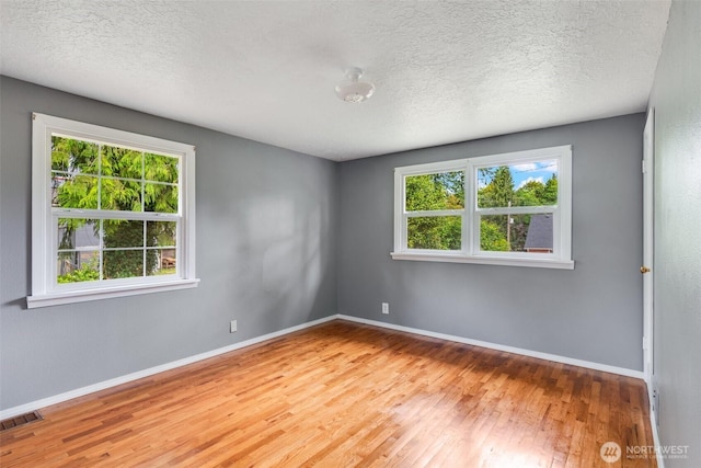 414 W Wyandotte Ave, Shelton, WA 98584 - empty room featuring plenty of natural light, hardwood / wood-style floors, and a textured ceiling