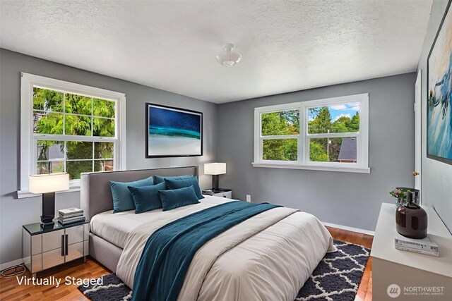 414 W Wyandotte Ave, Shelton, WA 98584 - bedroom featuring multiple windows, wood finished floors, and a textured ceiling