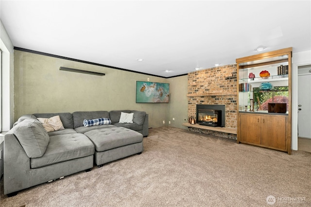 carpeted living room featuring a fireplace, ornamental molding, and recessed lighting