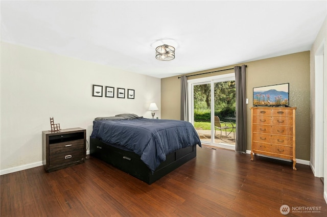 bedroom with access to outside, dark wood finished floors, and baseboards