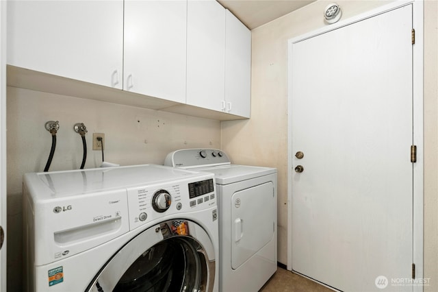 laundry area with cabinet space and separate washer and dryer