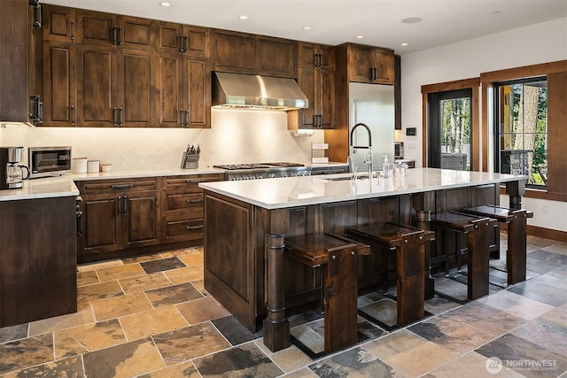 350 Kings Ct, Cle Elum, WA 98922 - kitchen featuring extractor fan, stone tile floors, light countertops, and recessed lighting