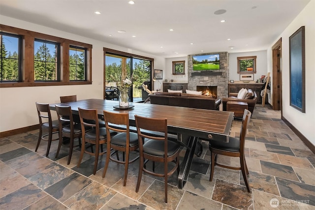 350 Kings Ct, Cle Elum, WA 98922 - dining room featuring baseboards, recessed lighting, stone tile flooring, and a stone fireplace