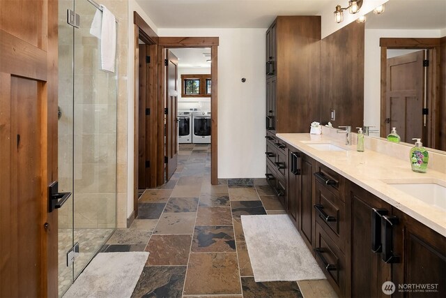 350 Kings Ct, Cle Elum, WA 98922 - full bath featuring separate washer and dryer, stone tile floors, a stall shower, double vanity, and baseboards