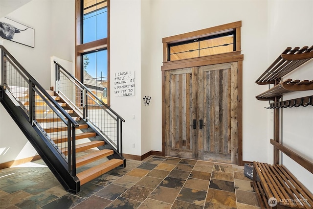 350 Kings Ct, Cle Elum, WA 98922 - foyer featuring a high ceiling, stone tile floors, baseboards, and stairway