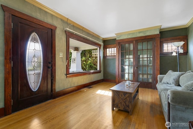 319 1st St, Auburn, WA 98002 - entrance foyer with wood finished floors, ornamental molding, healthy amount of natural light, baseboards, and french doors