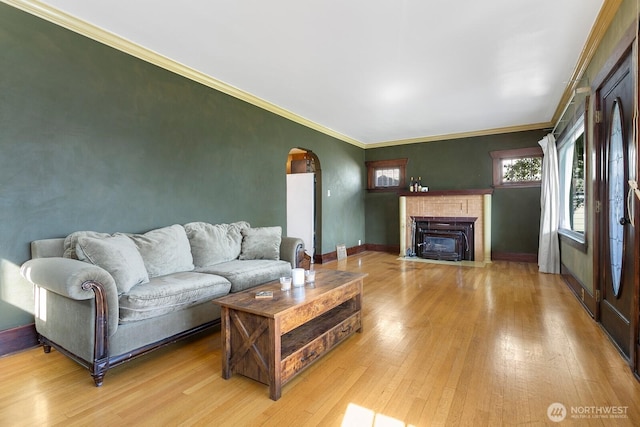 319 1st St, Auburn, WA 98002 - living room with arched walkways, light wood-style flooring, a fireplace with flush hearth, and ornamental molding