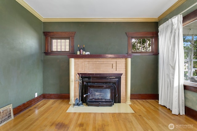 319 1st St, Auburn, WA 98002 - unfurnished living room featuring plenty of natural light, wood finished floors, crown molding, and a brick fireplace