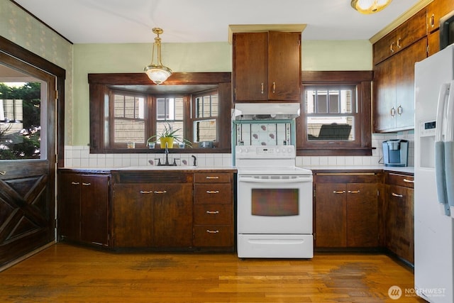 319 1st St, Auburn, WA 98002 - kitchen featuring white appliances, under cabinet range hood, healthy amount of natural light, and light countertops