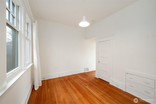 spare room with light wood finished floors and baseboards