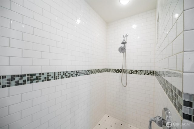 full bathroom with tiled shower