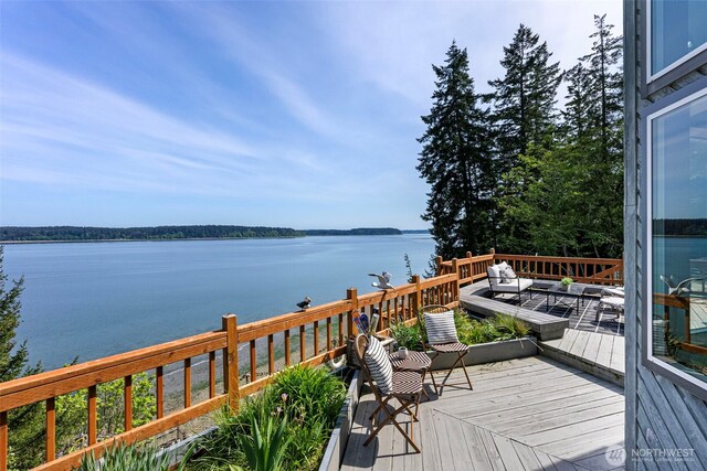wooden terrace featuring a water view