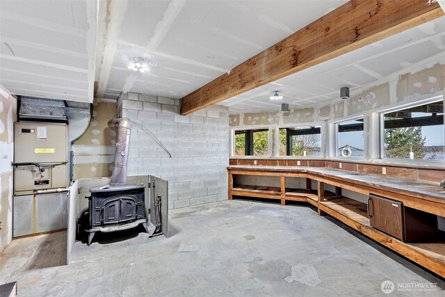 below grade area featuring a wood stove and a workshop area