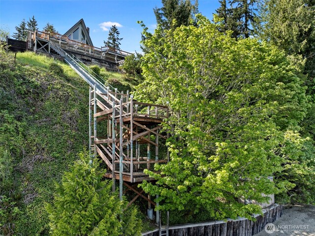 view of side of home featuring stairway