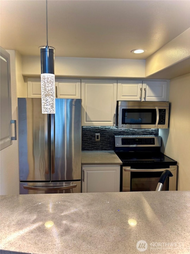 18621 Blueberry Ln Unit B206, Monroe, WA 98272 - kitchen featuring appliances with stainless steel finishes, white cabinetry, backsplash, and recessed lighting