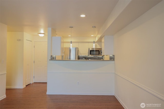 18621 Blueberry Ln Unit B206, Monroe, WA 98272 - kitchen with appliances with stainless steel finishes, wood finished floors, recessed lighting, white cabinets, and decorative light fixtures