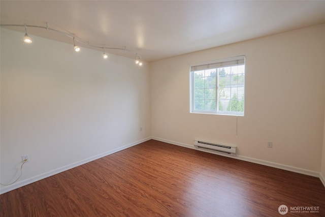 18621 Blueberry Ln Unit B206, Monroe, WA 98272 - spare room with baseboard heating, wood finished floors, and baseboards