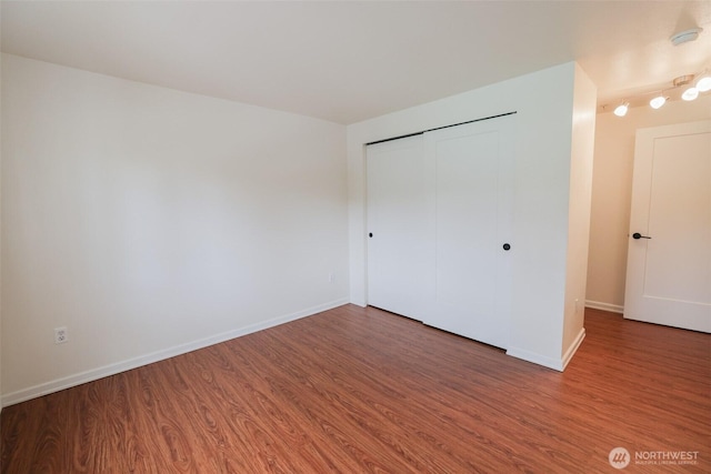 18621 Blueberry Ln Unit B206, Monroe, WA 98272 - unfurnished bedroom with wood finished floors, baseboards, and a closet
