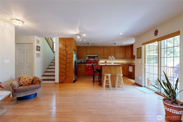 18 Blue Creek Rd, Walla Walla, WA 99362 - kitchen with stainless steel fridge, a kitchen bar, a kitchen island, open floor plan, and light wood-style floors