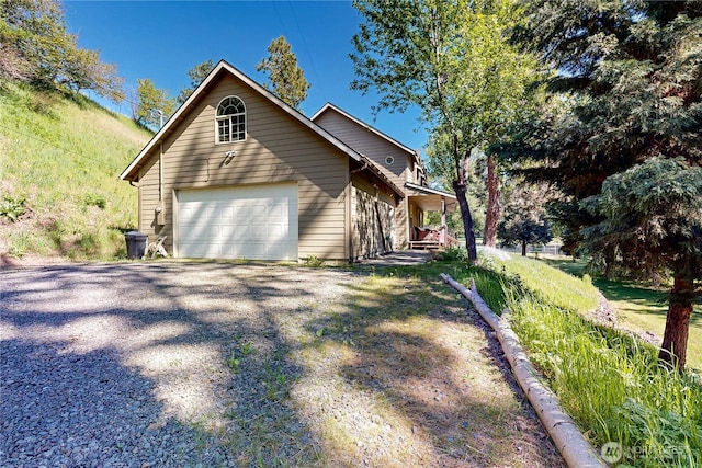 18 Blue Creek Rd, Walla Walla, WA 99362 - view of front facade with a garage, covered porch, and gravel driveway