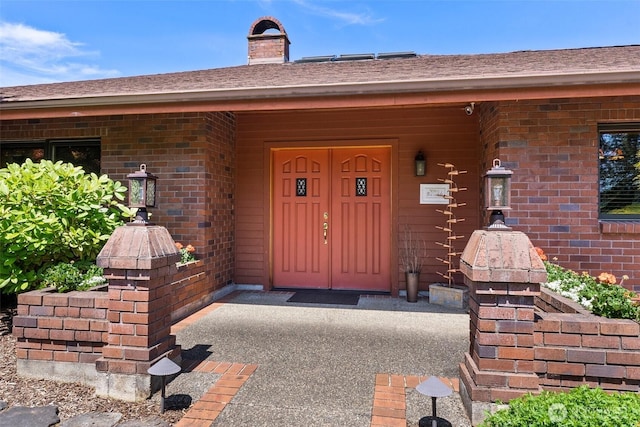55771 Mossyrock Ave, Mossyrock, WA 98564 - view of exterior entry featuring brick siding, a chimney, and covered porch