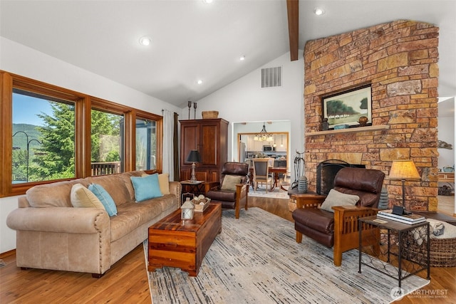 55771 Mossyrock Ave, Mossyrock, WA 98564 - living room featuring light wood-style floors, beamed ceiling, recessed lighting, a fireplace, and high vaulted ceiling