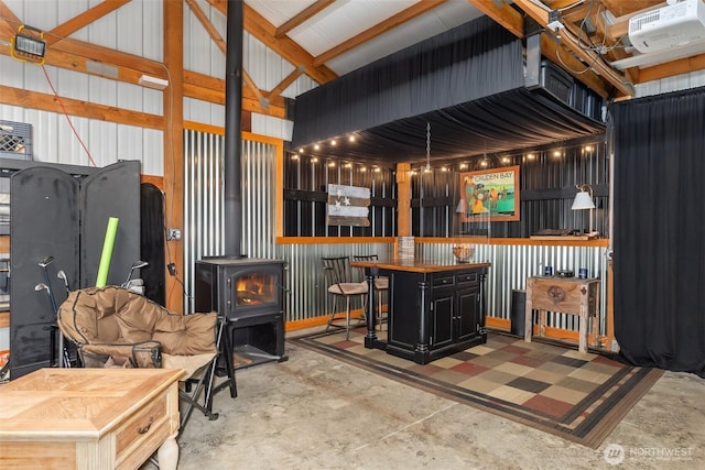 55771 Mossyrock Ave, Mossyrock, WA 98564 - indoor dry bar featuring a wood stove, unfinished concrete flooring, and lofted ceiling
