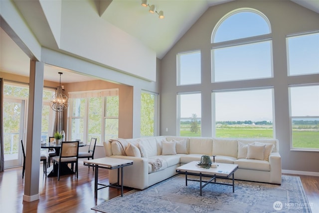 746 Van Dyk Rd, Lynden, WA 98264 - living area featuring healthy amount of natural light, a chandelier, wood finished floors, and high vaulted ceiling