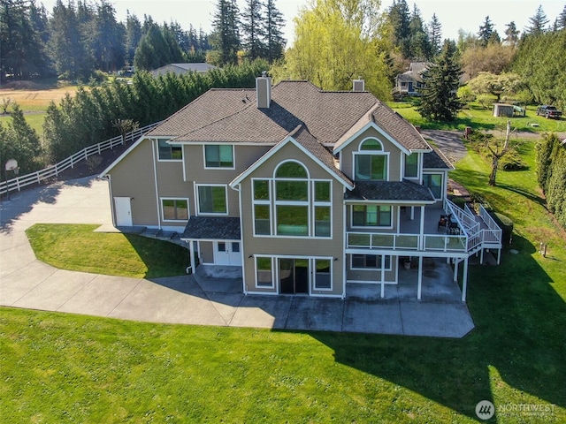 746 Van Dyk Rd, Lynden, WA 98264 - rear view of house with a patio area, a lawn, and a chimney