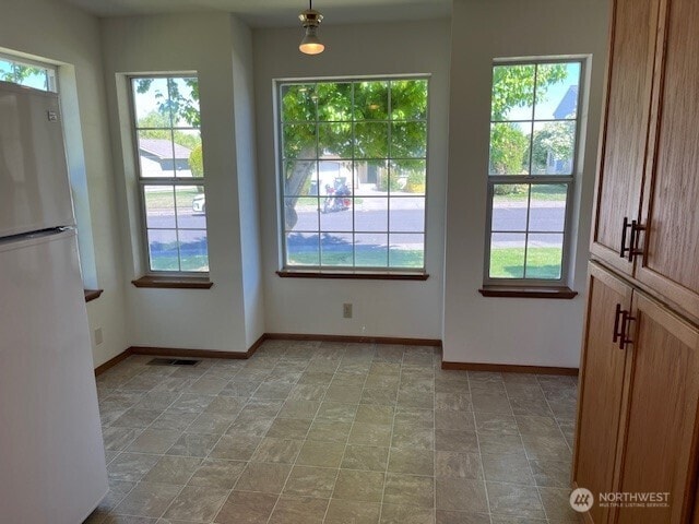 434 SE Stanford Pl, College Place, WA 99324 - entryway featuring plenty of natural light, baseboards, and stone finish floors