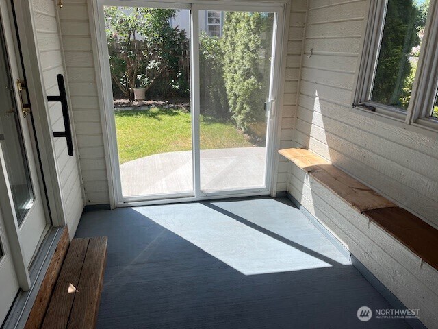434 SE Stanford Pl, College Place, WA 99324 - entryway featuring carpet, plenty of natural light, and wooden walls