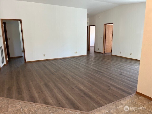 434 SE Stanford Pl, College Place, WA 99324 - unfurnished room featuring dark wood finished floors, baseboards, and lofted ceiling