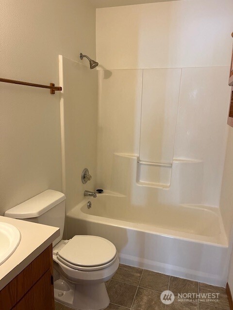 434 SE Stanford Pl, College Place, WA 99324 - bathroom with toilet, vanity, tub / shower combination, and tile patterned floors