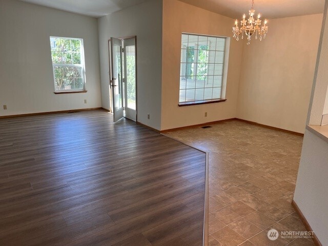 434 SE Stanford Pl, College Place, WA 99324 - unfurnished room with healthy amount of natural light, a chandelier, and baseboards