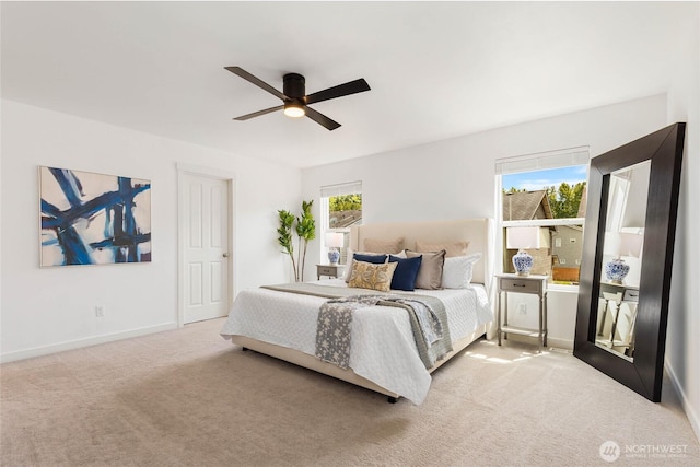 carpeted bedroom featuring baseboards and a ceiling fan