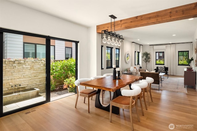 dining area featuring light wood-style floors, recessed lighting, and beamed ceiling
