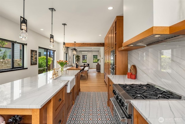 kitchen with custom exhaust hood, stainless steel range, brown cabinets, and recessed lighting