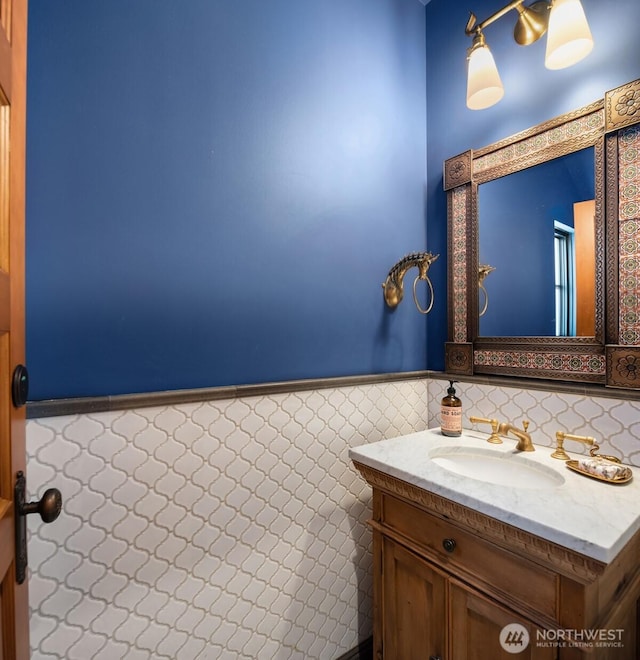 bathroom with wainscoting, tile walls, and vanity