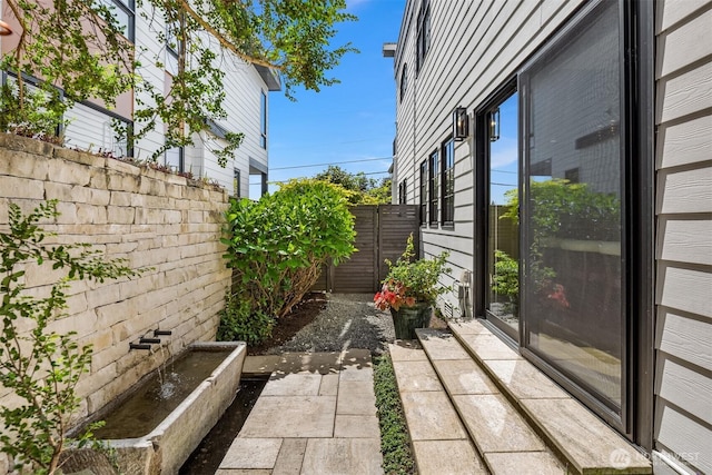 view of home's exterior with fence
