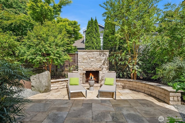 view of patio / terrace featuring an outdoor stone fireplace