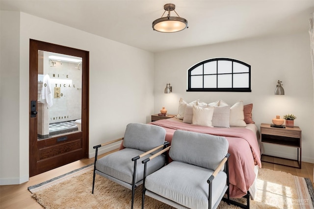 bedroom featuring wood finished floors and baseboards