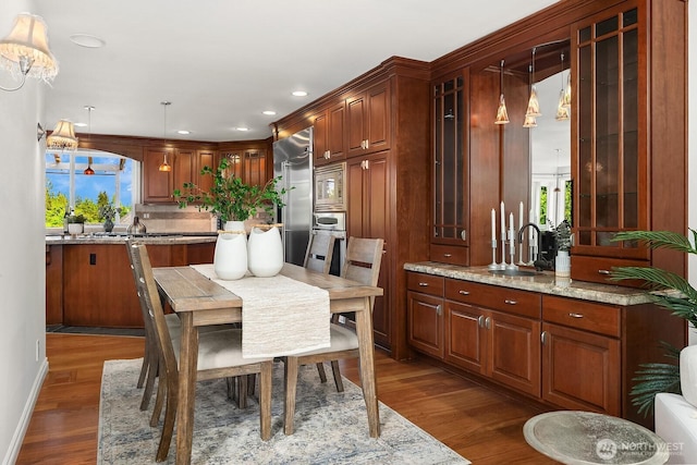 dining room featuring dark wood-type flooring, recessed lighting, and healthy amount of natural light