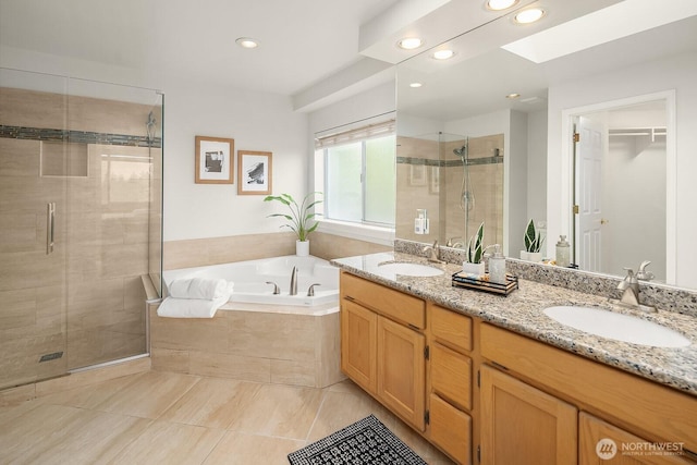 bathroom with a garden tub, a shower stall, tile patterned flooring, recessed lighting, and double vanity