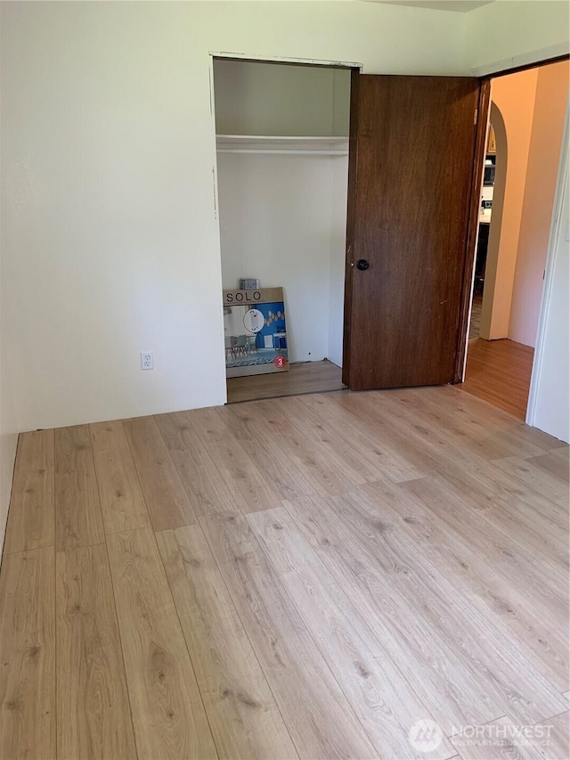 111 3rd St, Port Hadlock, WA 98339 - unfurnished bedroom with arched walkways, wood finished floors, and a closet