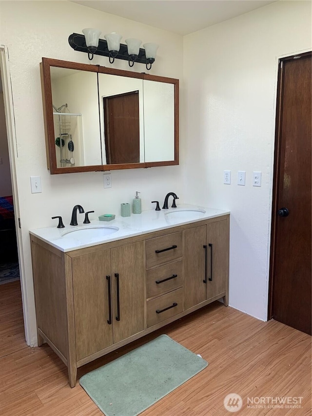 111 3rd St, Port Hadlock, WA 98339 - bathroom featuring wood finished floors and double vanity