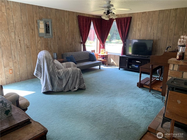 111 3rd St, Port Hadlock, WA 98339 - living room with wood walls, electric panel, carpet, and ceiling fan
