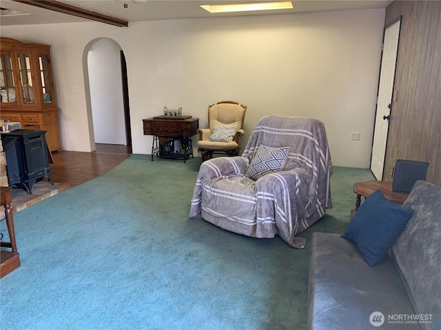 111 3rd St, Port Hadlock, WA 98339 - living room with carpet flooring, arched walkways, and a wood stove
