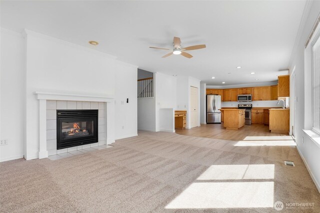 27922 146th Ave SE, Kent, WA 98042 - unfurnished living room with light carpet, a sink, ceiling fan, a tiled fireplace, and recessed lighting