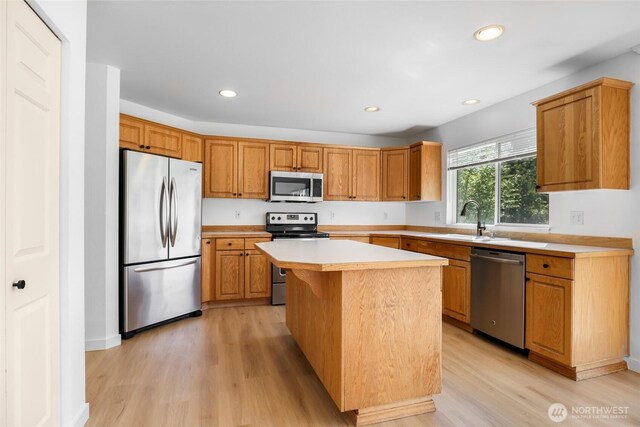 27922 146th Ave SE, Kent, WA 98042 - kitchen featuring appliances with stainless steel finishes, a sink, light wood-style flooring, light countertops, and recessed lighting